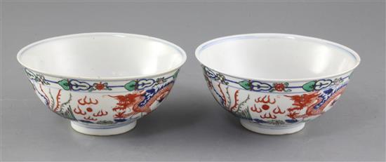 A pair of Chinese doucai dragon bowls, late 19th/early 20th century, diameter 15cm, one with small reglued chip to rim